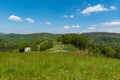 Beuatiful Slezske Beskydy mountains near Filipka hill in Czech republic with meadow, few isolated houses, dirt roads and hills on