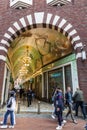 Beurspassage is mosaic covered passageway between the busy shopping corridors of Damrak and Nieuwendijk in Amsterdam, NL