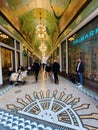 Beurspassage is mosaic covered passageway between the busy shopping corridors of Damrak and Nieuwendijk in Amsterdam, NL