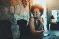 Beutiful black curly woman waiting in dark office room Royalty Free Stock Photo