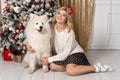 Beutiful blonde girl posing with white dog