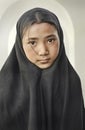 Beutiful girl with scarf and long black shawl inside a suni mosque