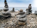 Beutiful image of towers made of balancing rocks on the ocean beach. Concept of harmony and balance Royalty Free Stock Photo