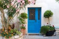 Beautiful vintage courtyard with lush greenery and marine blue wooden door in old Mediterranean costal town, Croatia