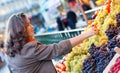 Beutiful woman buying grapes Royalty Free Stock Photo