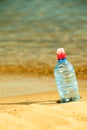 Bevarage. bottle of water drink on a sandy beach. Royalty Free Stock Photo