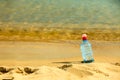 Bevarage. bottle of water drink on a sandy beach. Royalty Free Stock Photo