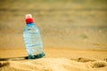 Bevarage. bottle of water drink on a sandy beach. Royalty Free Stock Photo