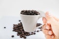 beverage background hand of woman hold cup with coffee bean place on white table with copy space. image for isolated, drink, food Royalty Free Stock Photo