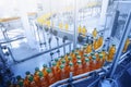 Beverage factory, Conveyor belt with juice in bottles, Industrial Interior in blue color, food and drink production line