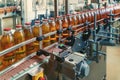 Beverage factory, food and drink production process, bottles with juice on conveyor belt