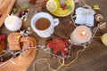 beverage, hot drink in a mug, leaves, foliage, garland, candles, top view of wooden table, good weather concept, outdoor tea party Royalty Free Stock Photo