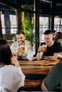 Beverage lifestyle concept with guys and girls having fun together at brewery bar restaurant Royalty Free Stock Photo