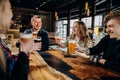 Happy group of friends drinking and clinking with beer and cocktails at brewery bar restaurant Royalty Free Stock Photo