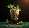 a beverage topped with chocolate liquid and mint leaves