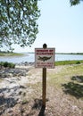 Beware Of Alligators sign at the waterfront city park in Sunset Beach, North Carolina Royalty Free Stock Photo