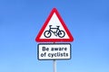 Beware of cyclists road safety sign against blue sky