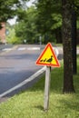 Beware of ducks crossing. Red triangle caution road sign Royalty Free Stock Photo