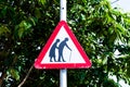 Beware of the elderly traffic sign on the light pole. Triangle traffic sign for the warnings. Royalty Free Stock Photo