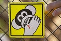 Beware of monkey yellow sign on fence