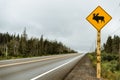 Watch out for moose. Warning yellow sign and Canadian highway Royalty Free Stock Photo