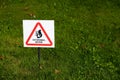 Beware of squirrel sign on grass close up Royalty Free Stock Photo