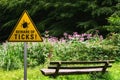 Beware of ticks at a bench in the nature Royalty Free Stock Photo