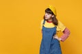 Bewildered puzzled girl teenager in french beret, denim sundress looking aside, standing with arms akimbo isolated on