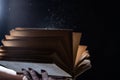 Bewitched Book With Magic Glows In The Darkness Royalty Free Stock Photo