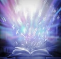 Bewitched Book With Magic Glows In The Darkness The blurred book that is bewitched with magic, the magic light in the dark, with. Royalty Free Stock Photo