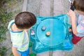 Two boys playing with a Beyblade, spinning top kid toy. Popular