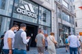 Adidas Turkish store in Taksim territory and some costumers buying clothes and others walking on Istiklal Independence street