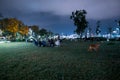 Turkish people looking sitting resting having fun on grass in Karakoy public park near sea for relaxation leisure summer nights Royalty Free Stock Photo