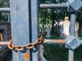 Historical Ottoman graveyard in the garden of Kasimpasa mosque from behind iron gate with rusty chains