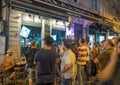 Turkish people and tourists watching world cup football matches together in a bar outside at night in summer for soccer sport