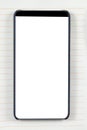 Bezel less smartphone with blank screen on a notepad background
