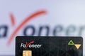 Bhairahawa, Nepal - June 27 2020: Man holds Payoneer Prepaid MasterCard against laptop computer. Payoneer funds were recently put