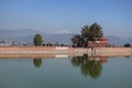 Reflection in a water pond of a stone wall and building on December 23, 2019 in Bhaktapur, Kathmandu, Nepal