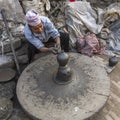 BHAKTAPUR, NEPAL - Nepalese man working in his pottery workshop.