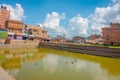 BHAKTAPUR, NEPAL - NOVEMBER 04, 2017: Close up of traditional urban scene with an artificial pond with ducks swimming at