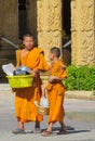 Young Buddhist monk samanera in Thailand temple wat walking on the street