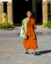 Young Buddhist monk samanera in Thailand temple wat walking on the street