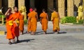 Young Buddhist monk samanera in Thailand temple wat walking on the street
