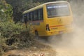 Bhojpur , Nepal - January 10, 2023 , Very dusty road , A school bus of Nepal carrying students