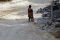 Bhojpur , Nepal - January 10, 2023: A young poor Nepali Girl working in roadside to earn his livelihood