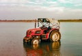 Cleaned Tractor standing in Water, Reflection seen in river water