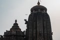 Juxtaposition of an airplane flying over Chitrakarini Temple in Bhubaneswar, Odisha, India