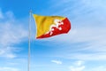 Bhutan flag over blue sky background