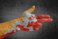 Bhutan flag painted on male hand like a gun