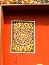 Bhutan traditional carved wooden decoration on red door
